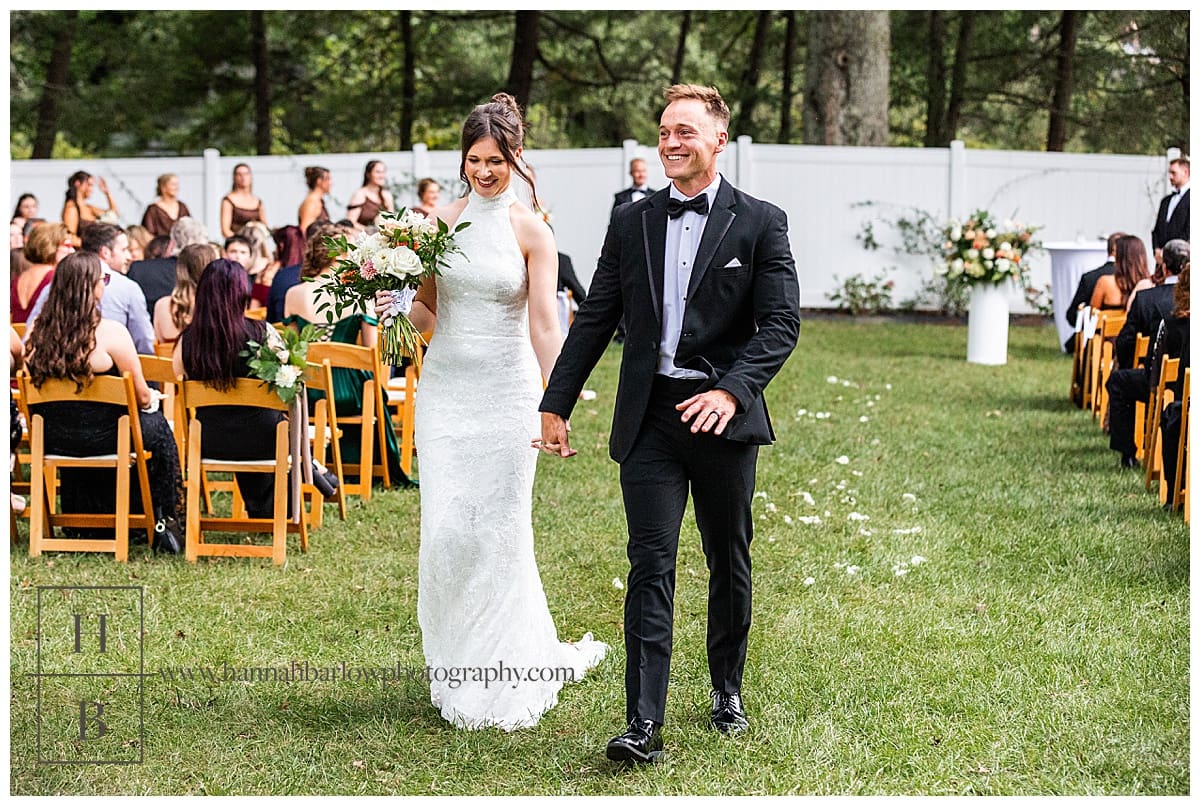 bride and groom walk back down wedding aisle