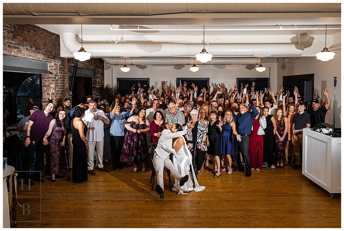 group photo at wedding of all guests on dance floor