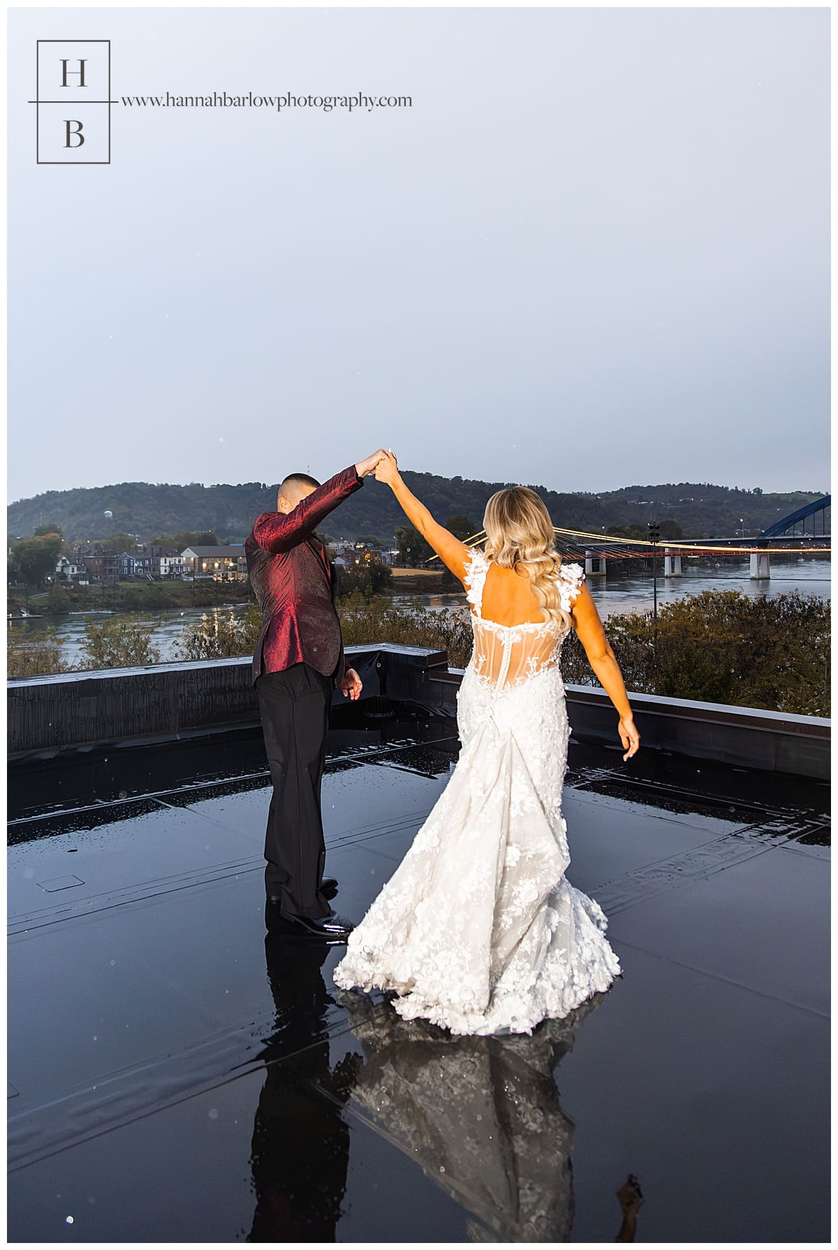 bride and groom dance on rooftop in rain