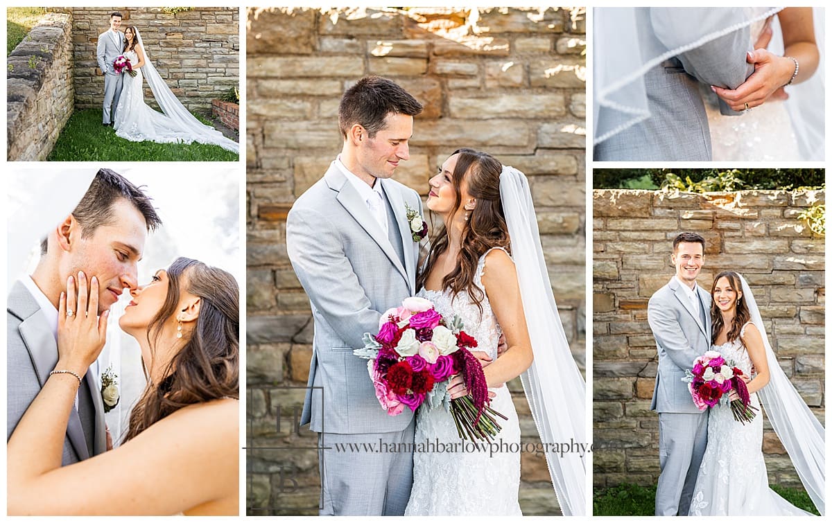 bride and groom pose by stone wall